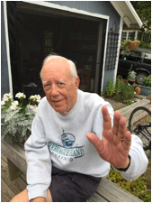 An old person sitting on a bench
Description automatically generated