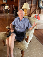 An old person sitting in a chair
Description automatically generated